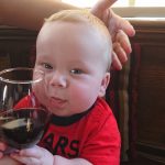 French baby drinking wine