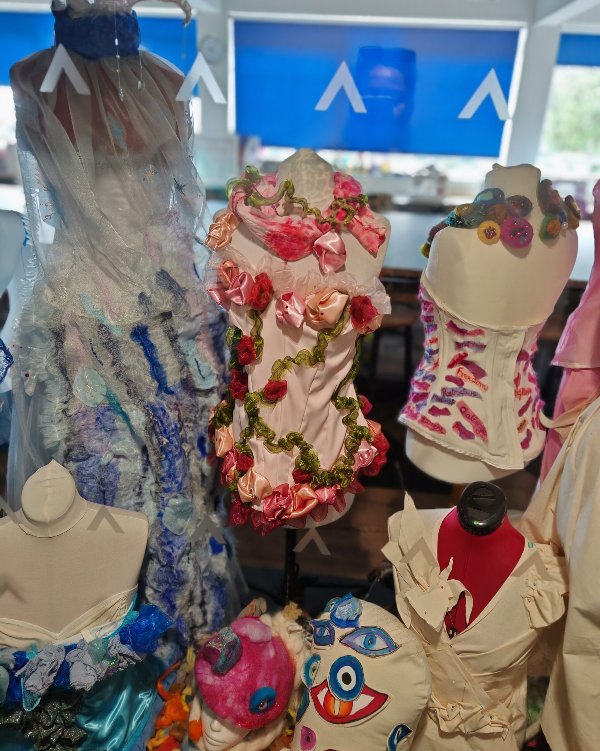 Costumes made by students in a school display. The creations are mainly dresses and corsets with flowers. Costumes made by students in a school display. The creations are mainly dresses and corsets with flowers.