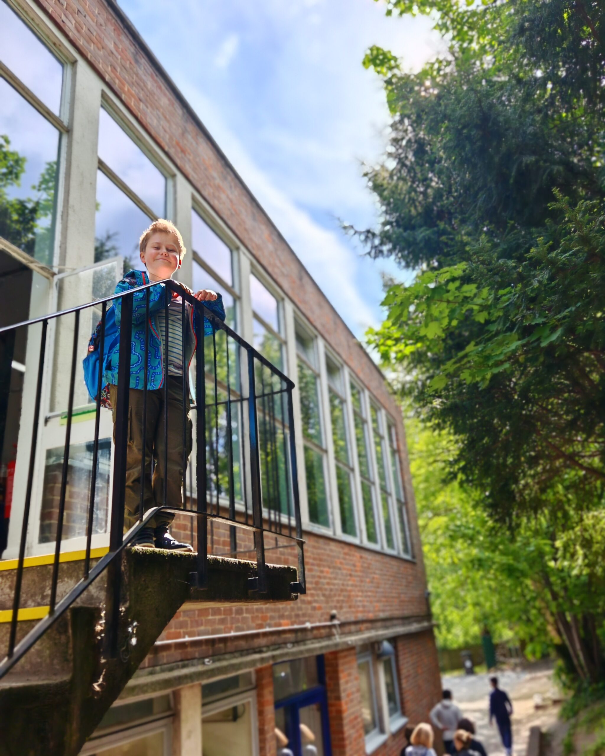 White little boy standing in Alleyn's Hampstead during an open day. 