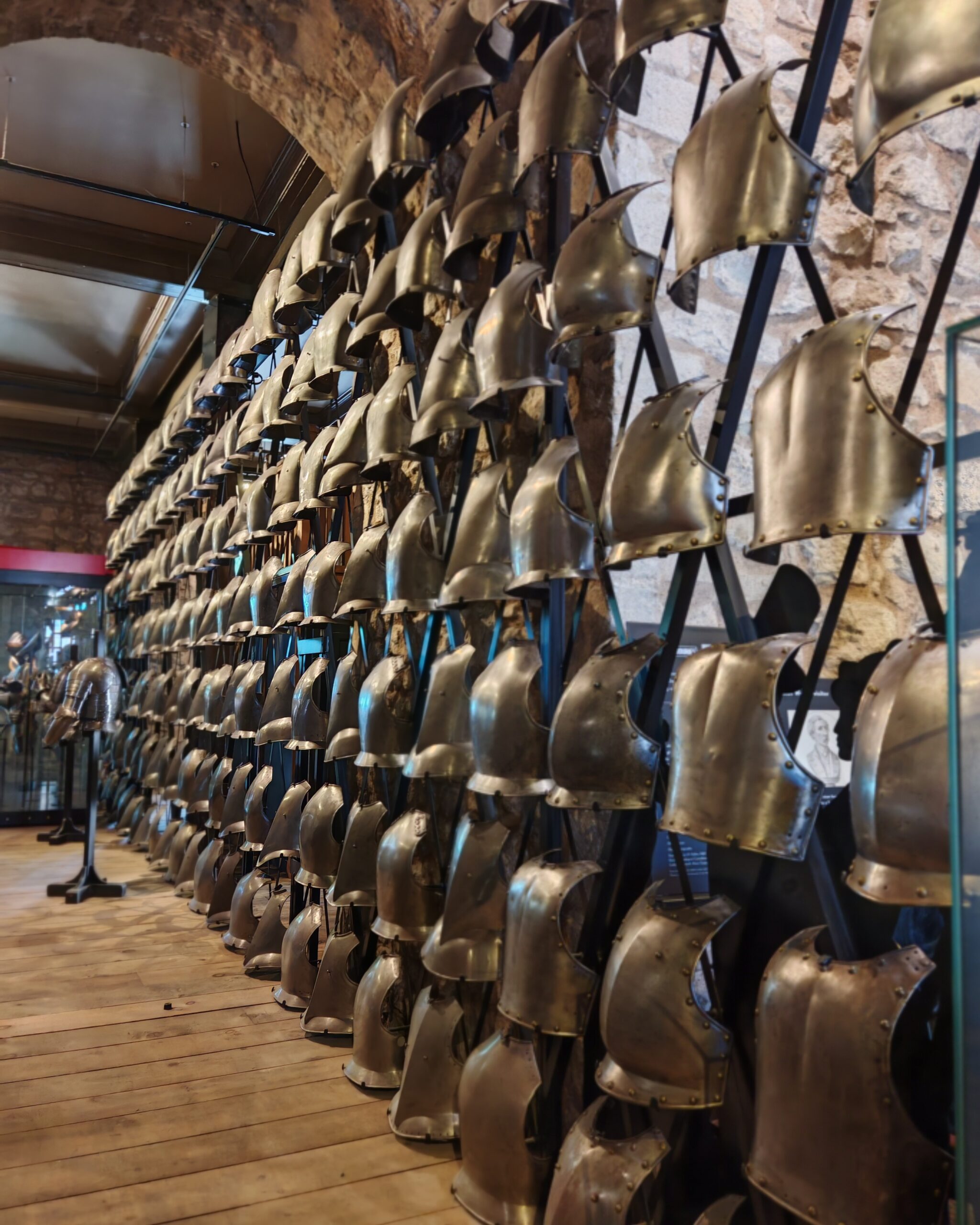 series of medieval armours lined up on a wall in the gate of Tower of London. series of medieval armours lined up on a wall in the gate of Tower of London.