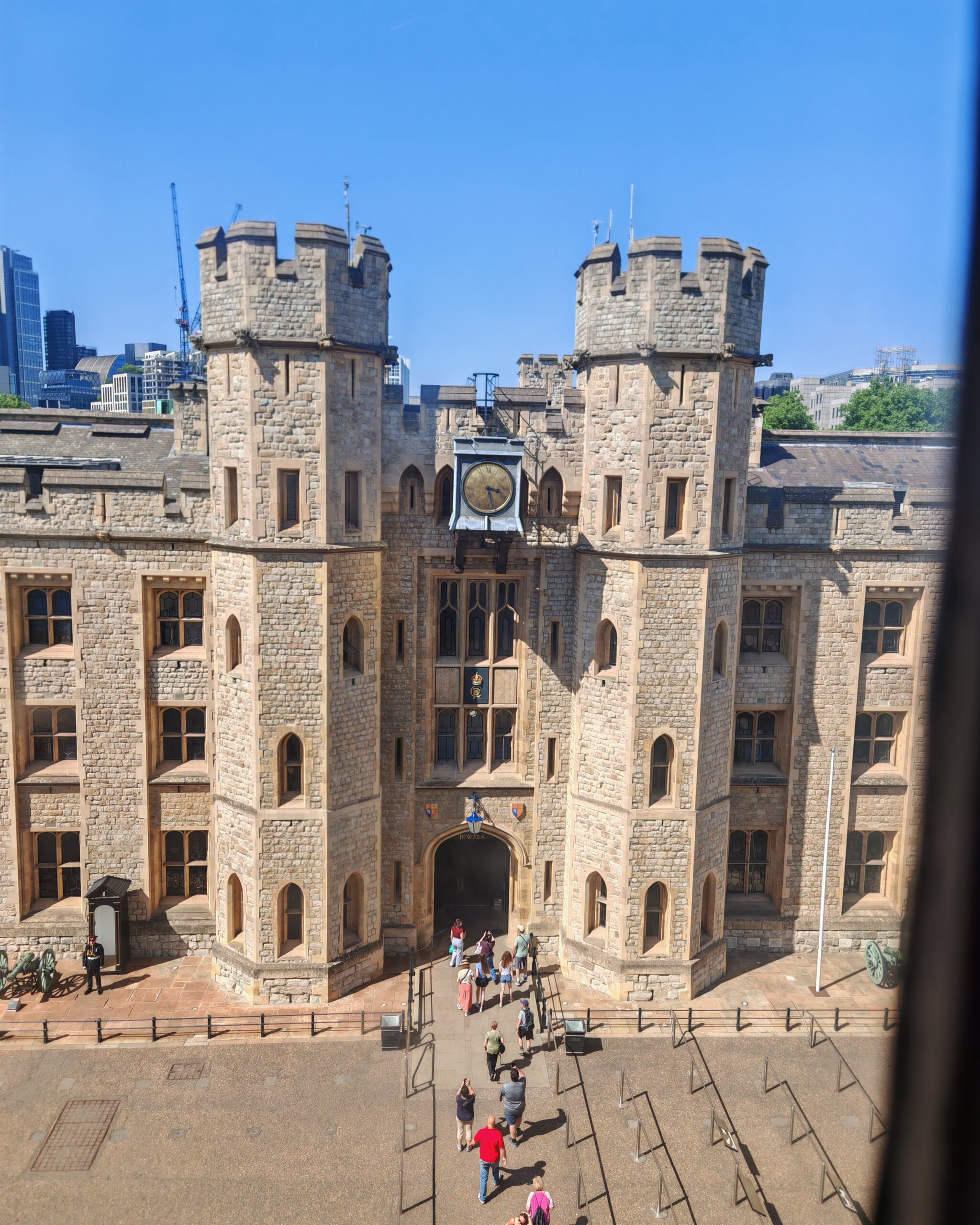 Tower of London entrance to the Crown Jewels exhibition, view from above inside the museum on a blue summer day Tower of London entrance to the Crown Jewels exhibition, view from above inside the museum on a blue summer day