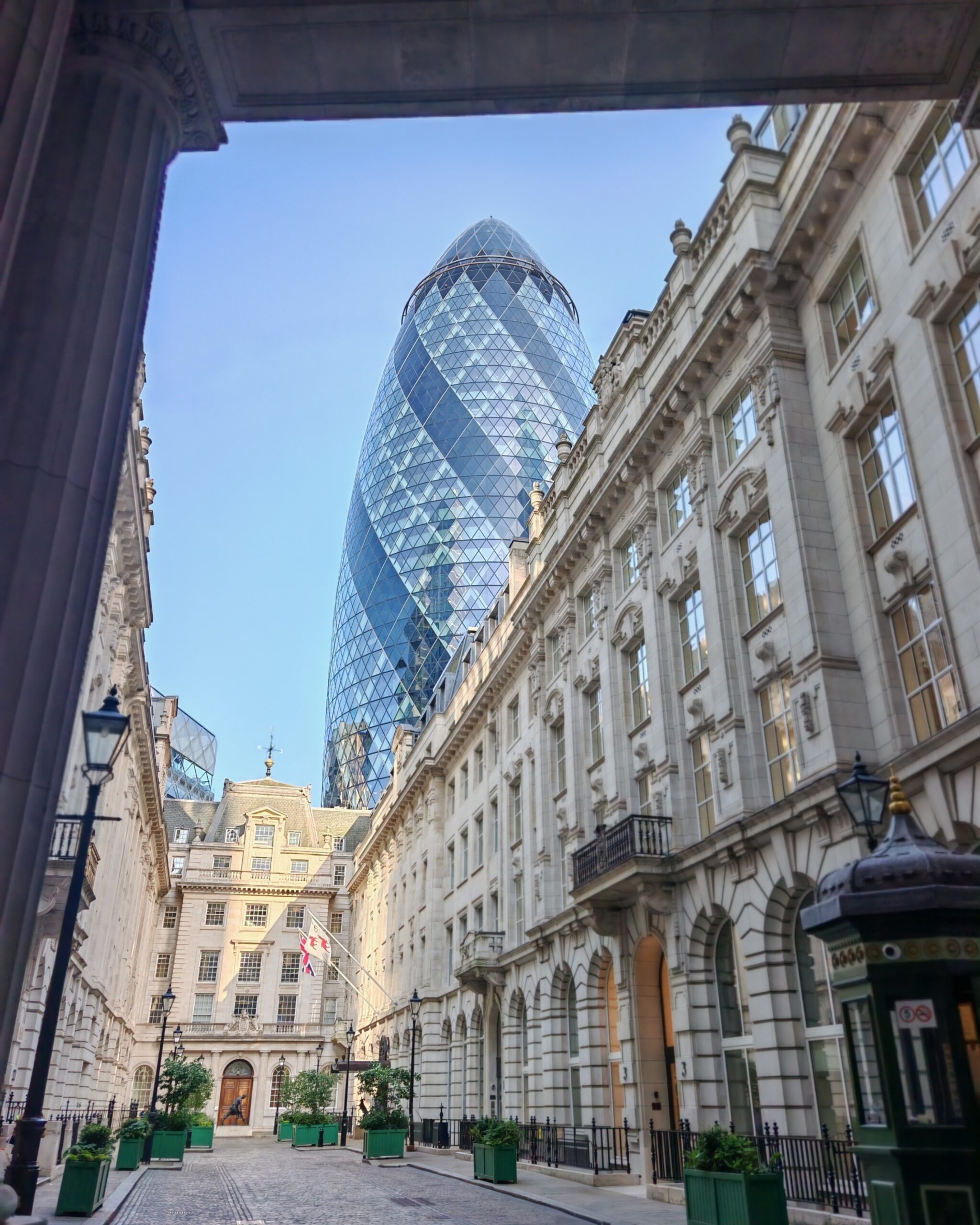 Buildings in the City district of London with the Gherkin in the background on a light sunny day Buildings in the City district of London with the Gherkin in the background on a light sunny day