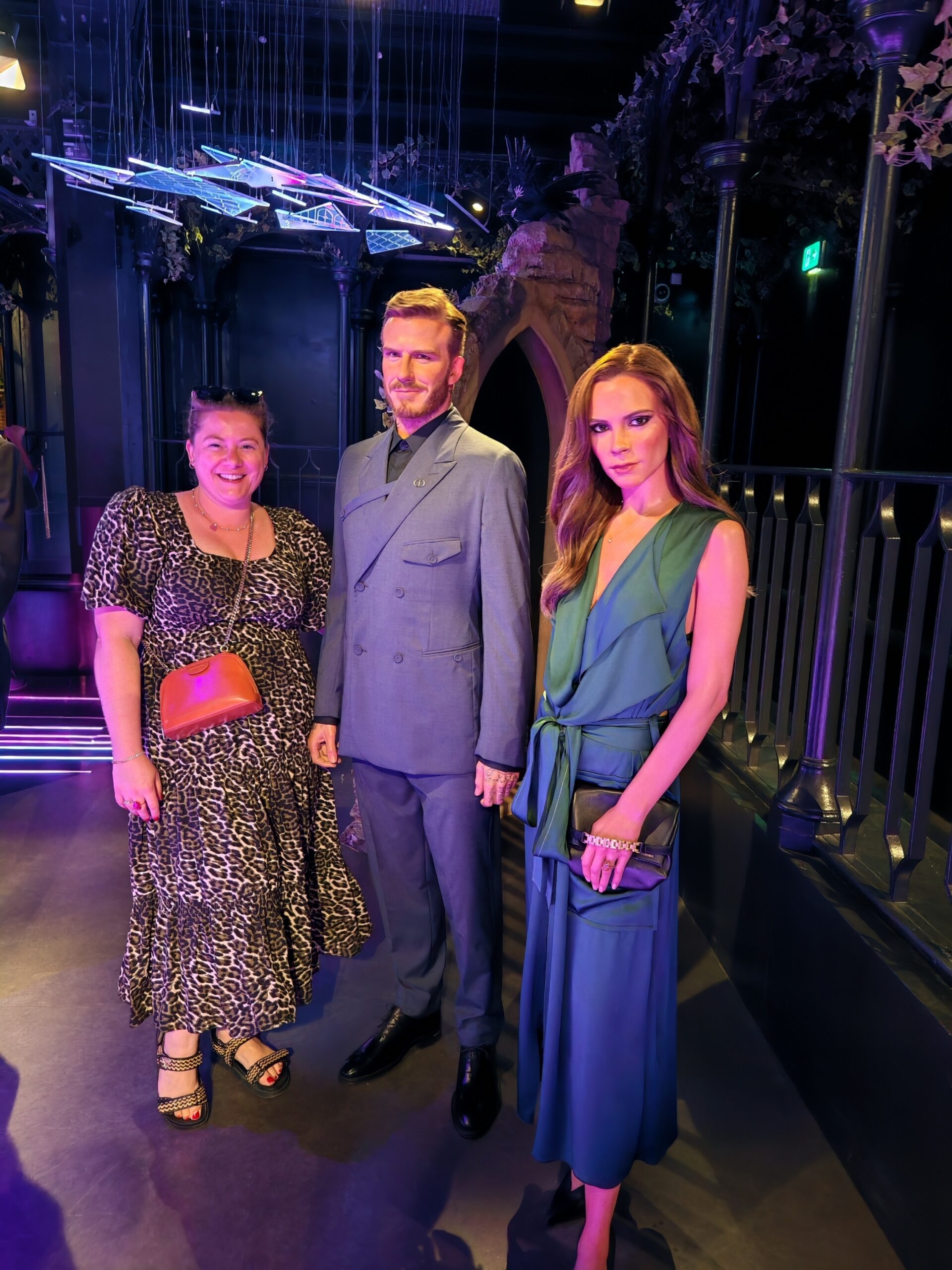 white woman at Madame Tussauds London, posing next to David and Victoria Beckham waxworks in the museum white woman at Madame Tussauds London, posing next to David and Victoria Beckham waxworks in the museum