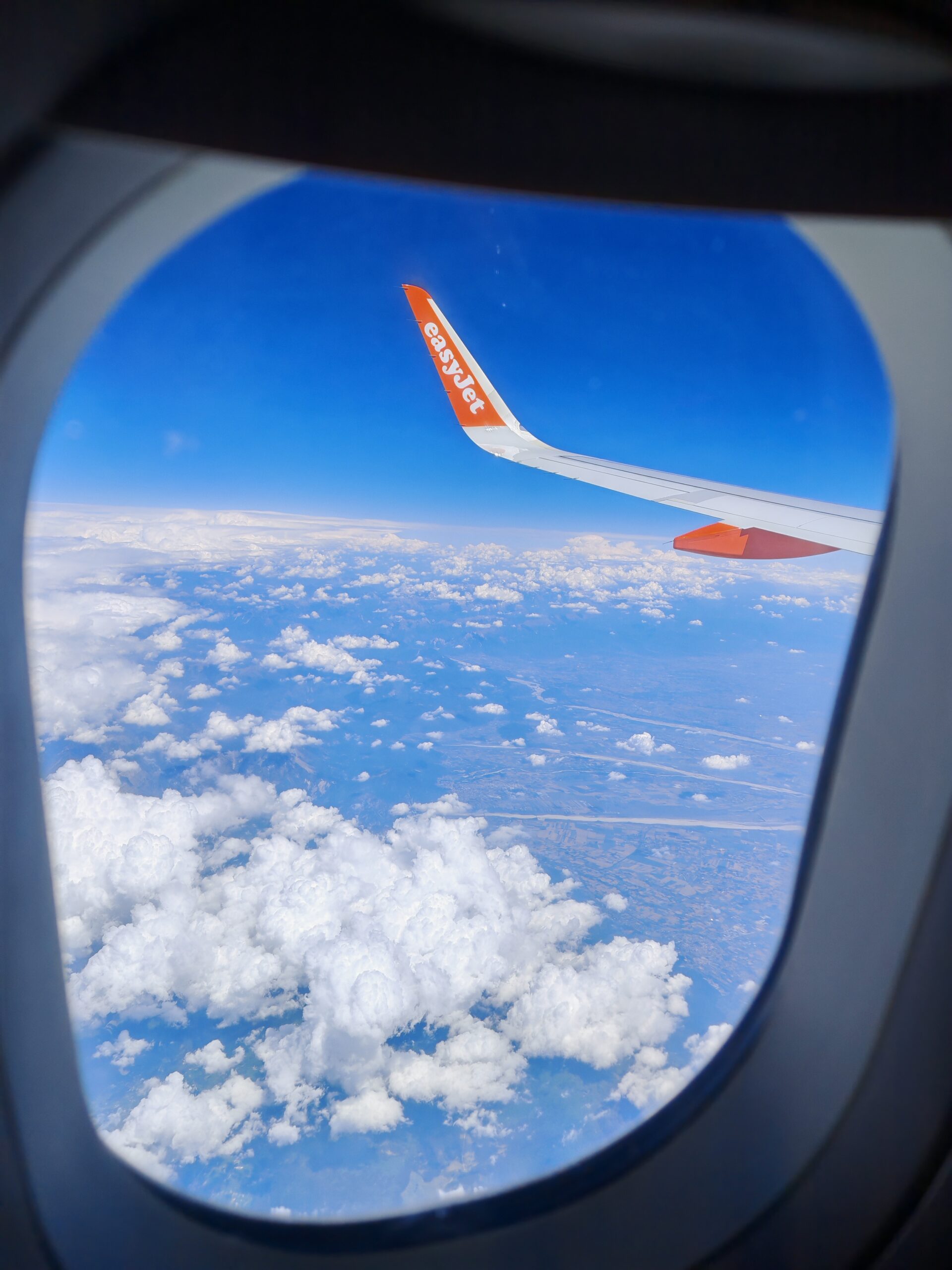Photo taken from the cabin of an Easyjet plane through the window, where you can see the Croatian land in the distance