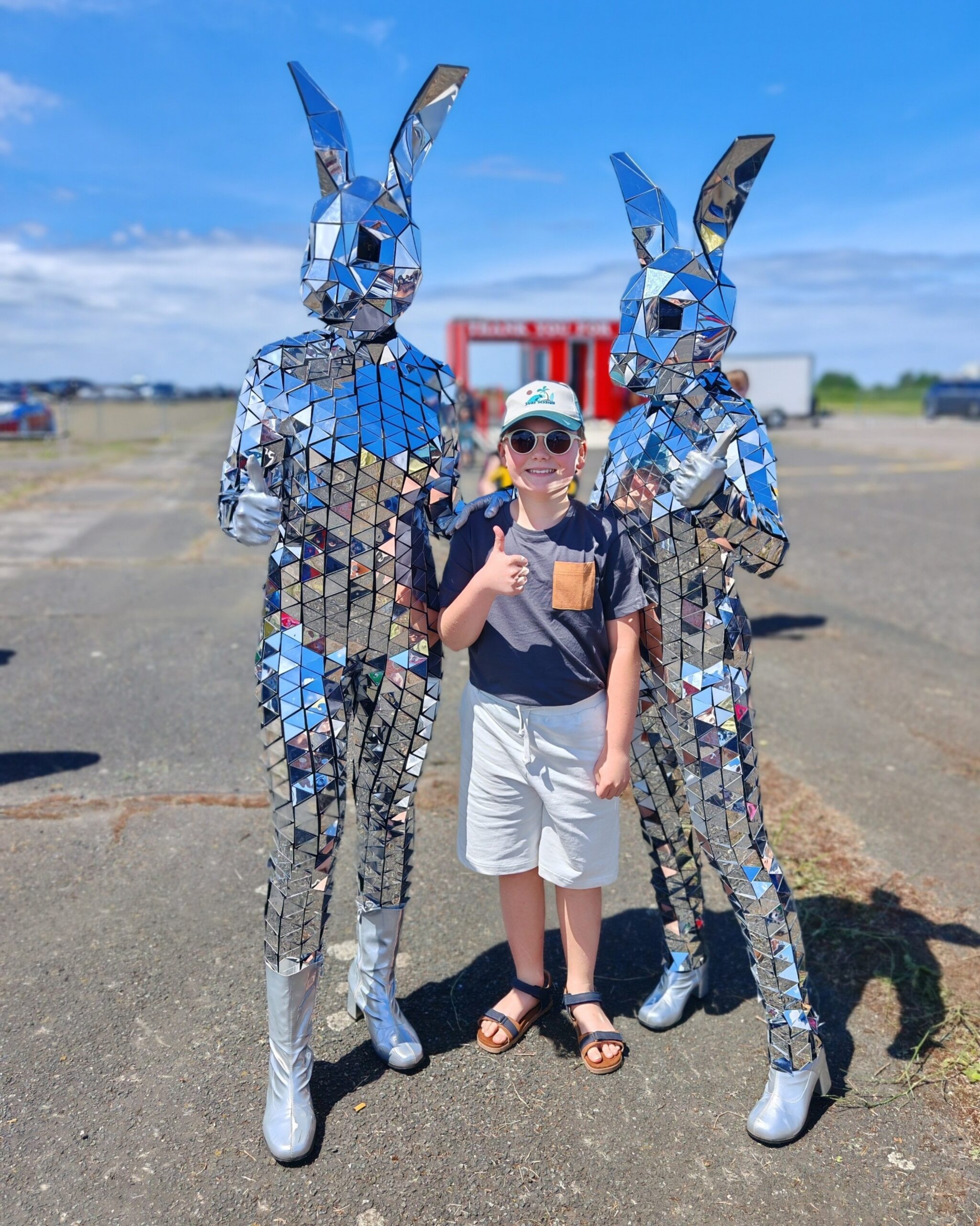 White little boy in white shorts posing with two disco ball bunnies at a fun fair in Kent White little boy in white shorts posing with two disco ball bunnies at a fun fair in Kent