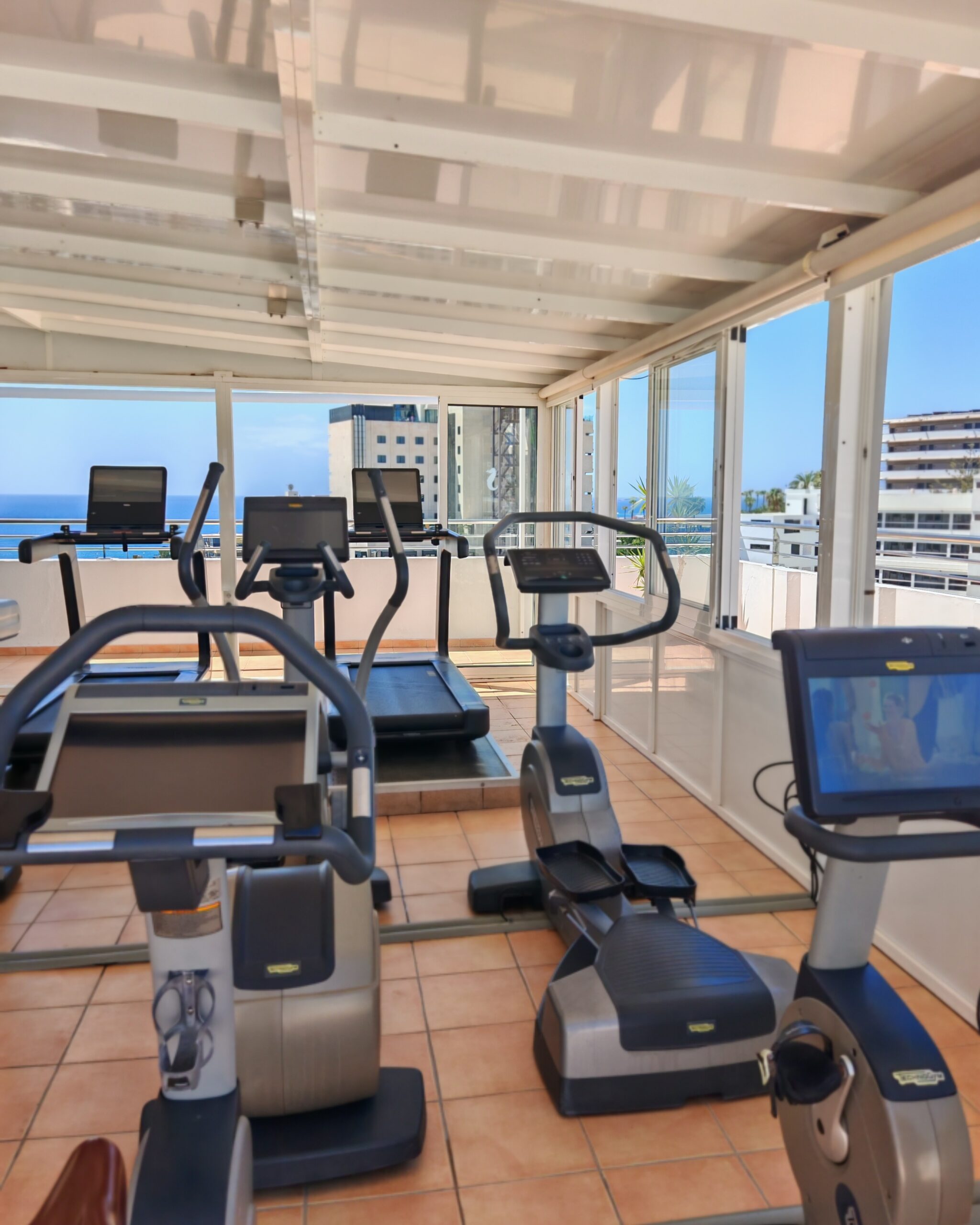 The gym room with treadmills and other machines on the top floor of the Seaside Sandy Beach Hotel in Maspalomas