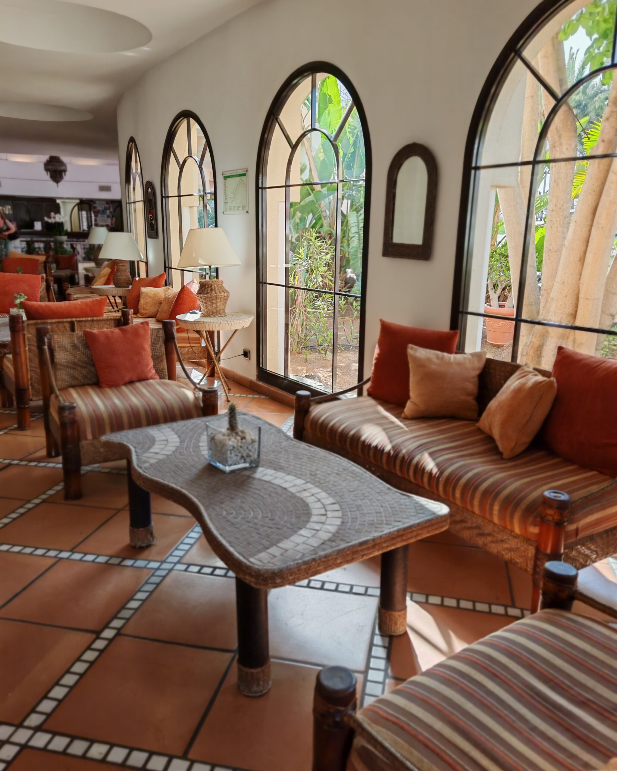 Moroccan inspired decor with a table and chairs in the Sandy Beach Hotel lobby