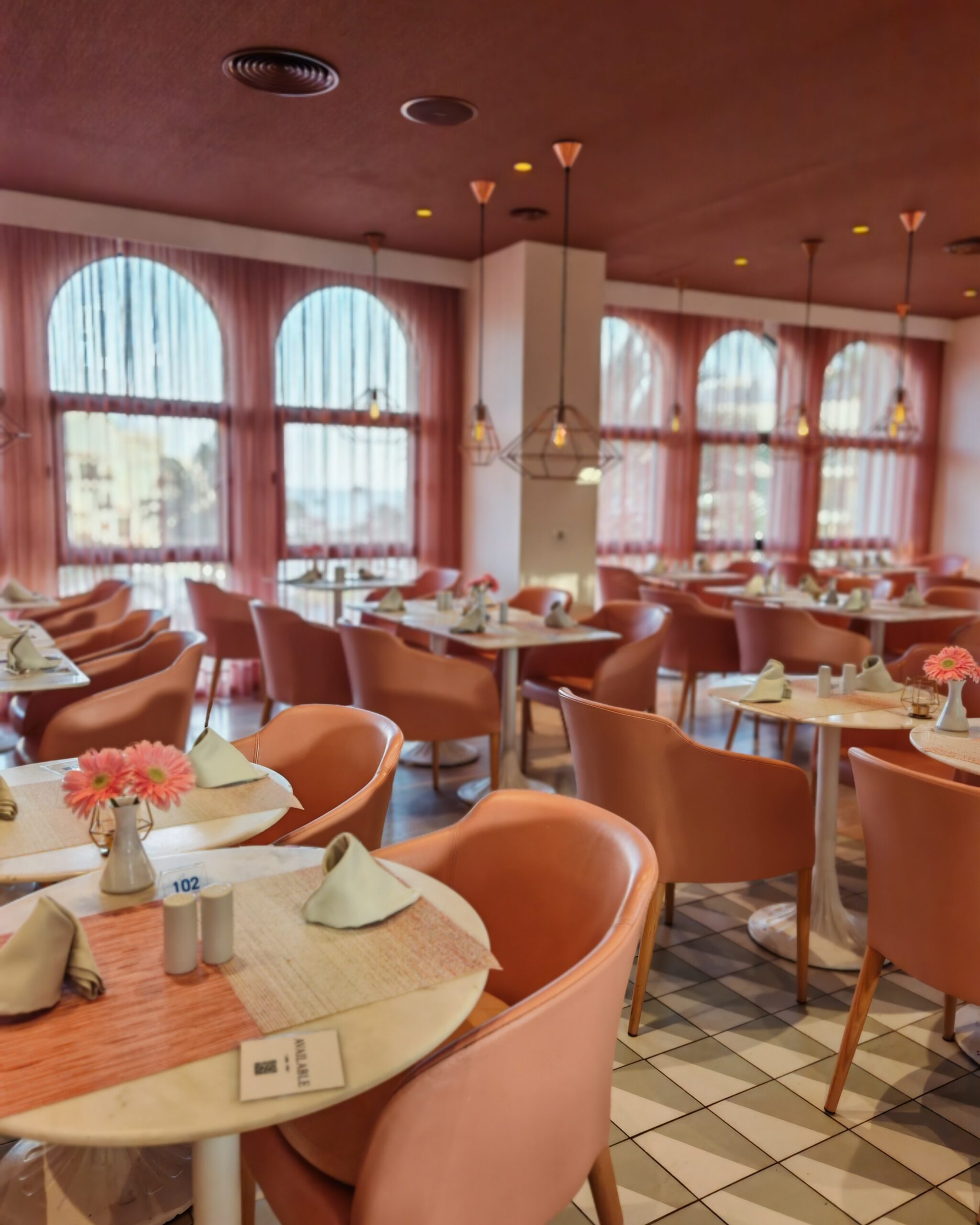 Pink themed restaurant at the Seaside Sandy Beach Hotel in Gran Canaria with pink chairs and modern decor