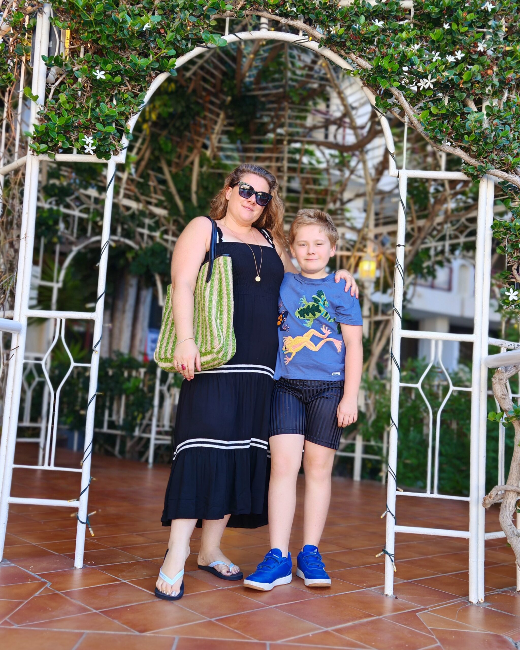 White woman and white little boy standing under an arch of Moroccan Style at the Seaside Sandy Hotel in Gran Canaria