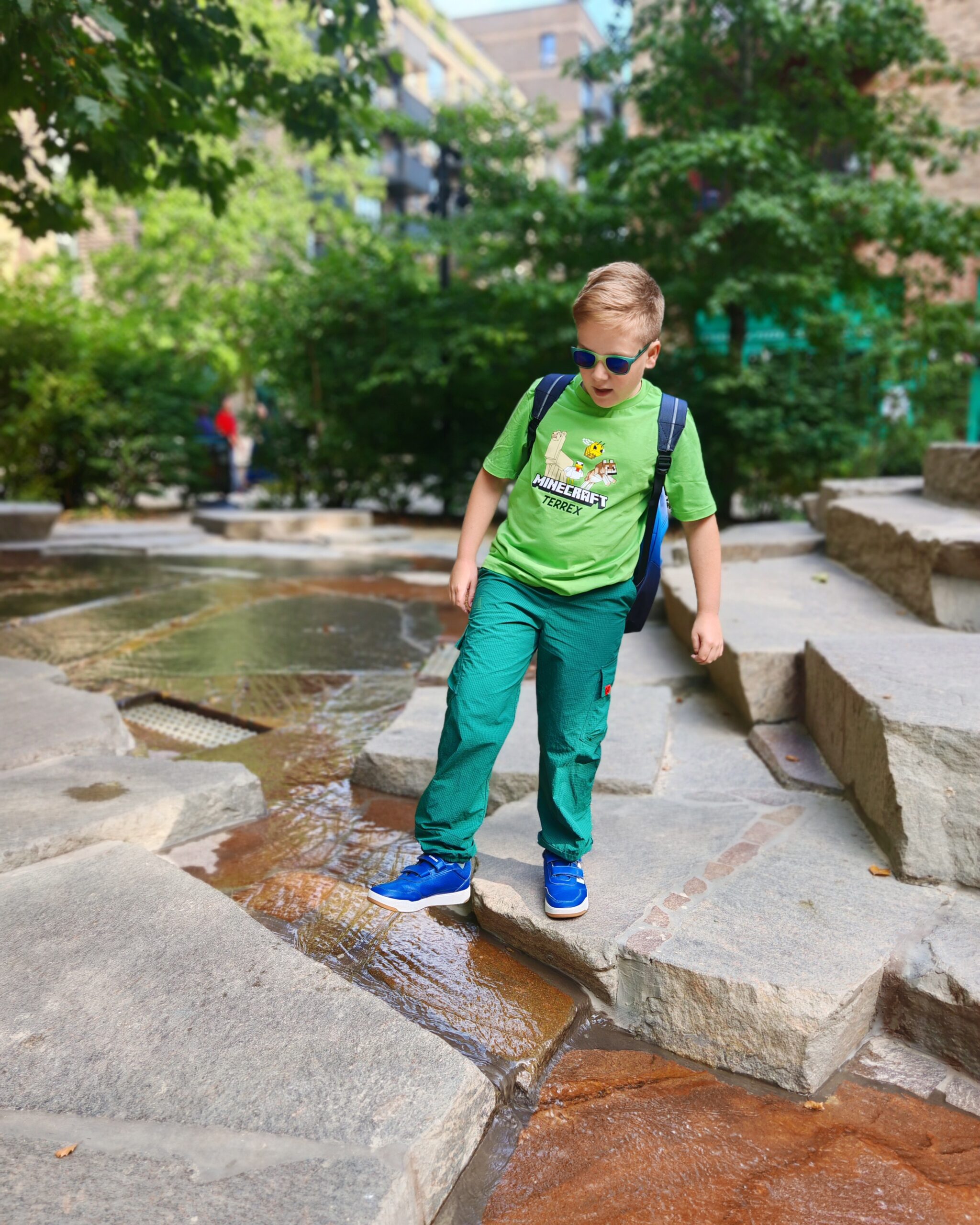 White little boy wearing a bright green tee from the latest adidas x Minecraft Collaboration at a playground in Elephant & Castle