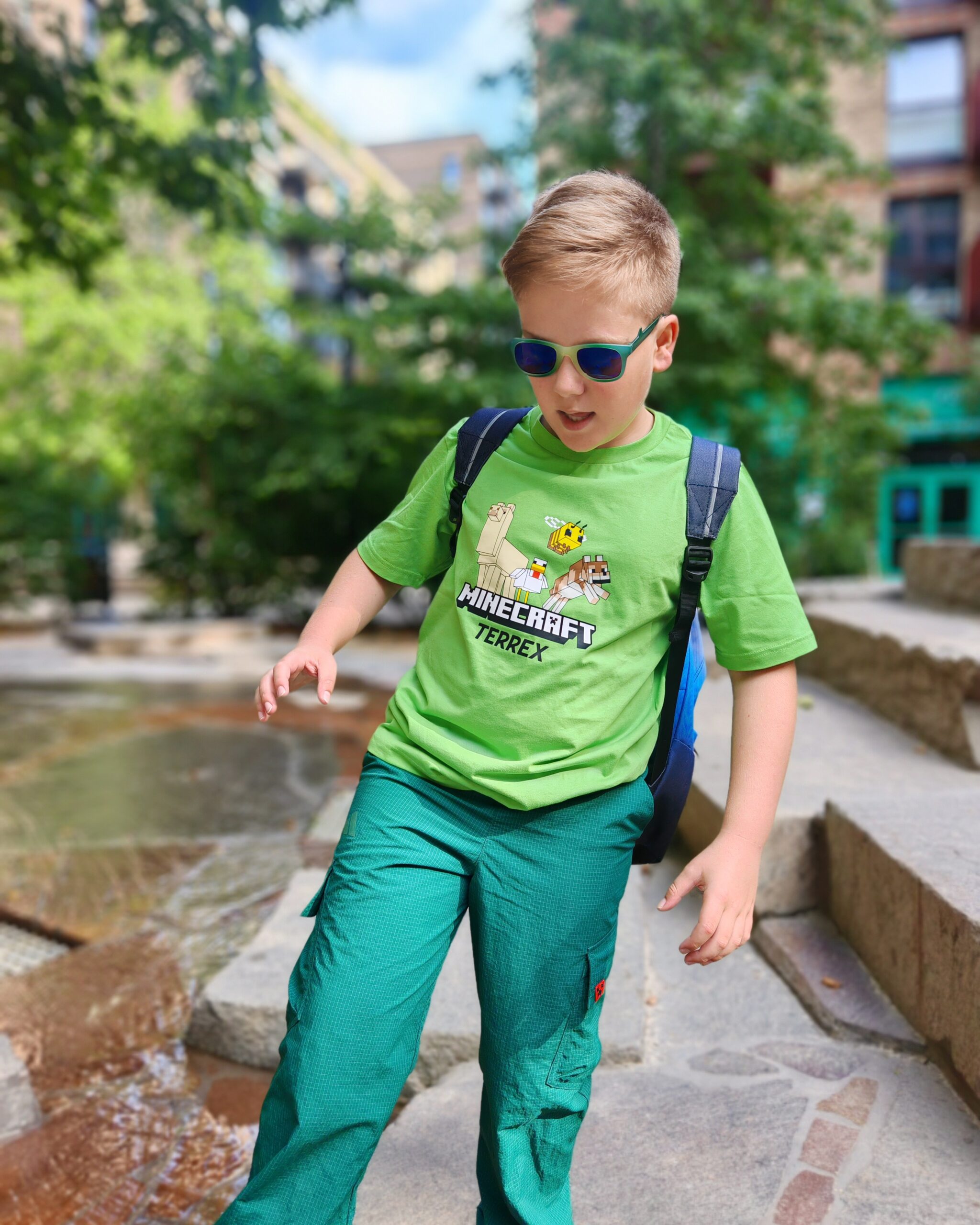 White little boy wearing a bright green tee from the latest adidas x Minecraft Collaboration at a playground in Elephant & Castle