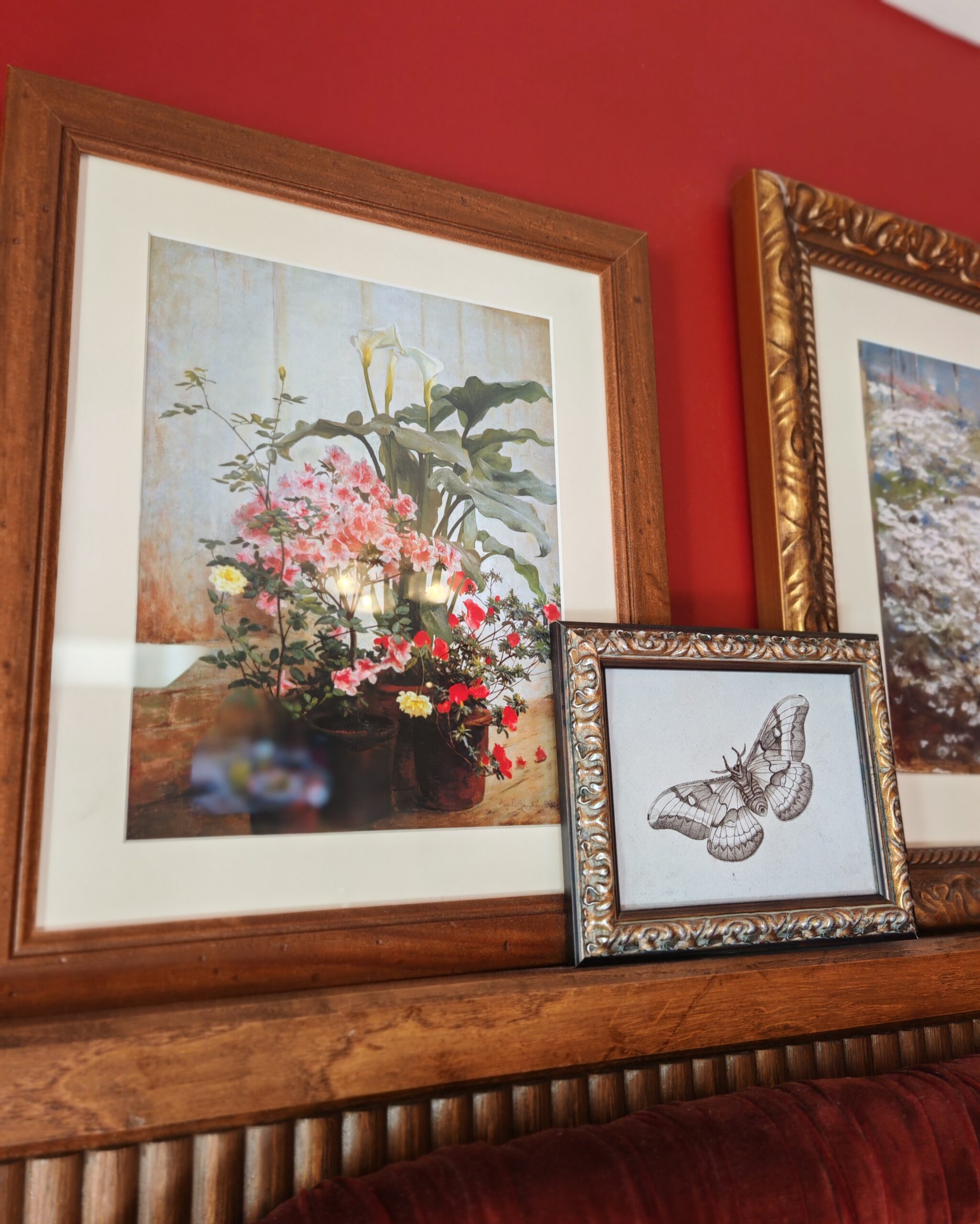 series of frames on top of a bed with an aquarelle of a pot of flowers and the drawing of a butterfly on the right corner series of frames on top of a bed with an aquarelle of a pot of flowers and the drawing of a butterfly on the right corner
