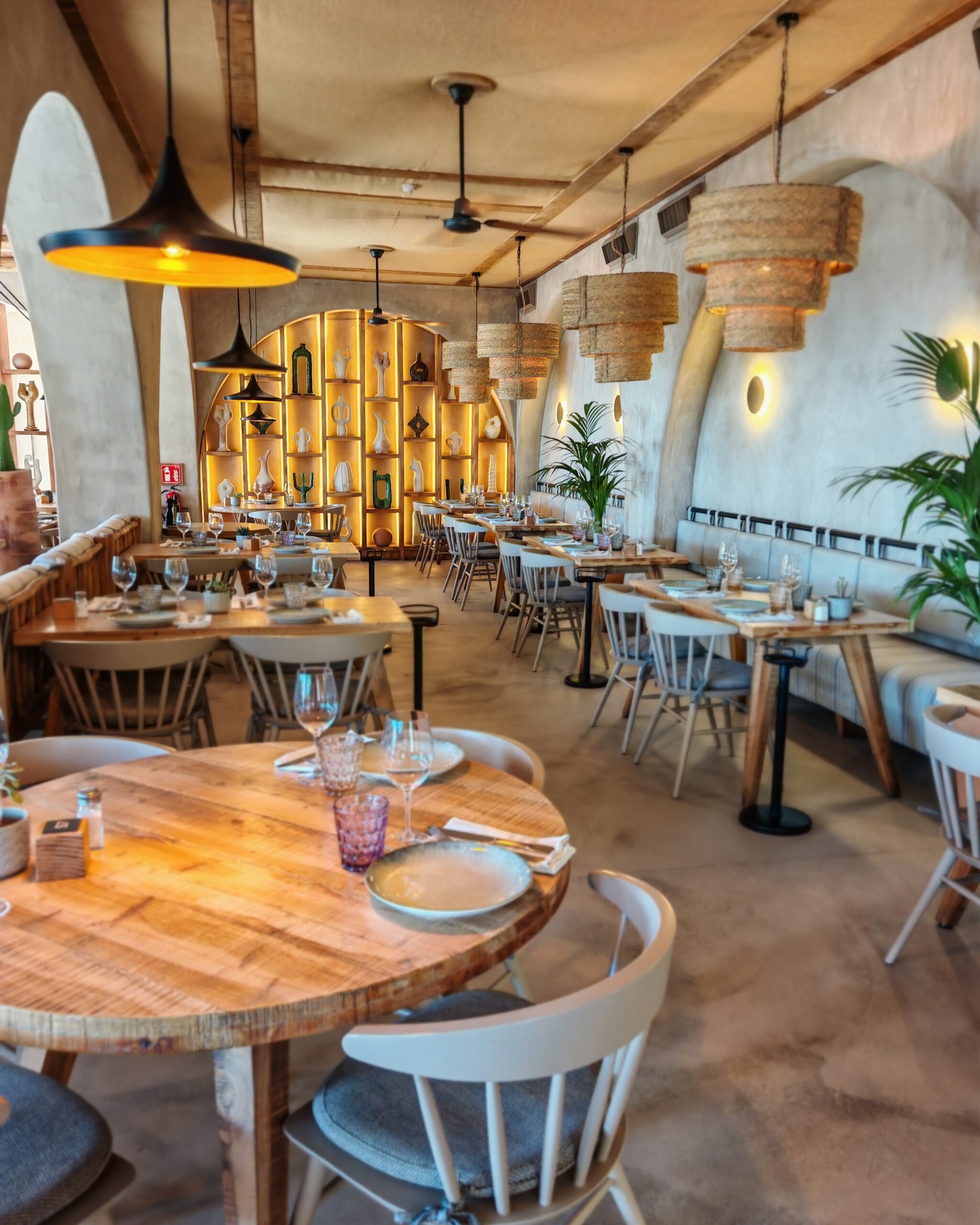 interiors of the Gammarus Restaurant & Beach Club in Lloret de mar with a light lighting and tables set up for customers to arrive interiors of the Gammarus Restaurant & Beach Club in Lloret de mar with a light lighting and tables set up for customers to arrive