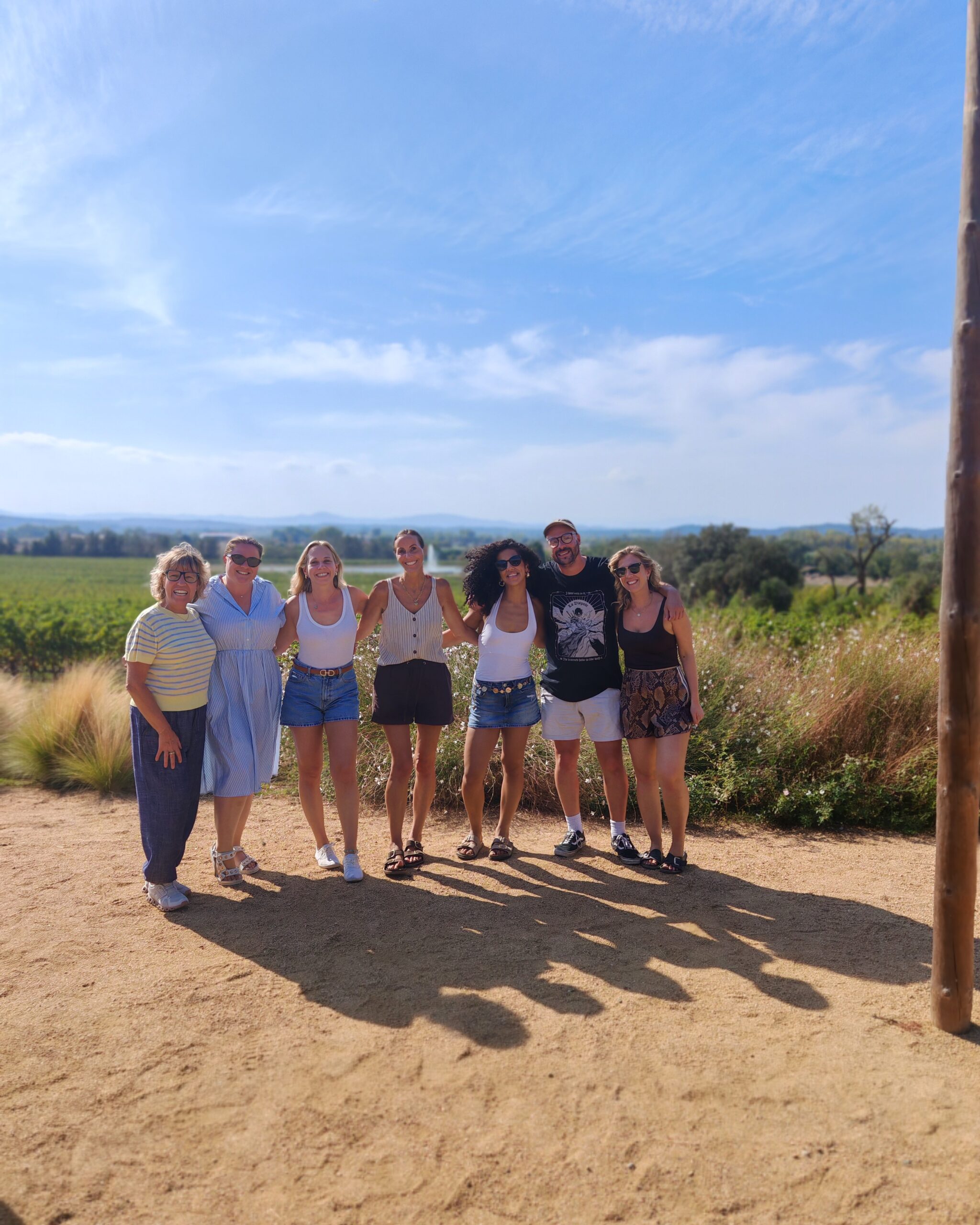 a group of bloggers posing at Mas Gelis vineyards in Spain a group of bloggers posing at Mas Gelis vineyards in Spain